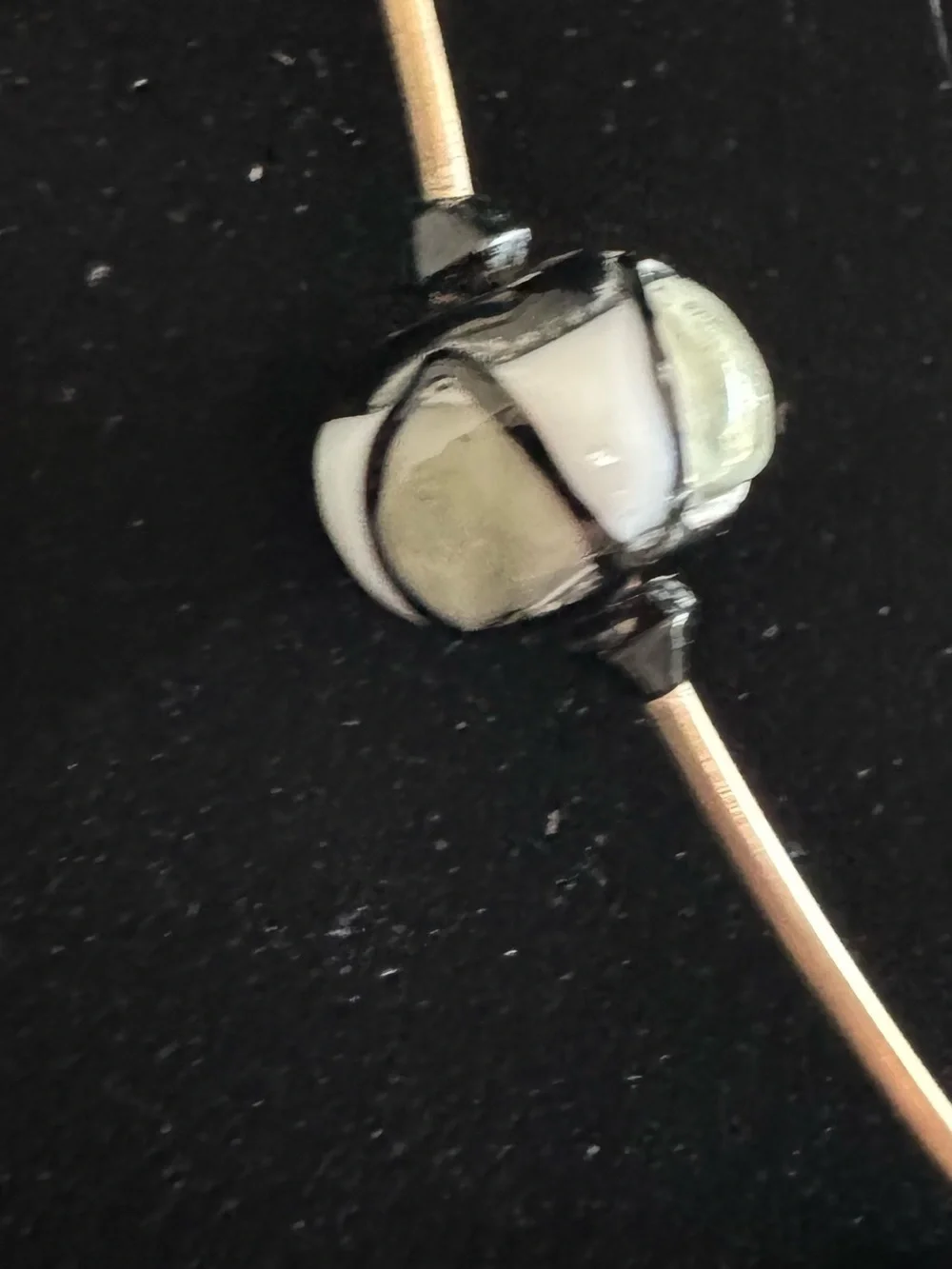 Black & silver geometric necklace featuring patterned spherical glass beads 22”